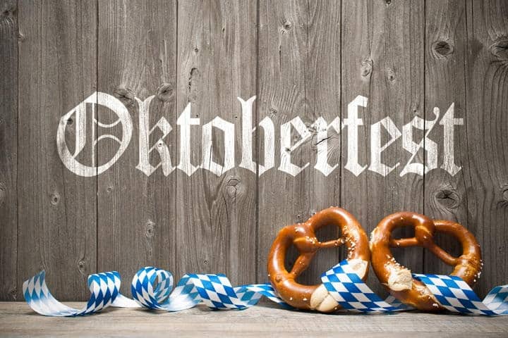 Oktoberfest lettering on weathered boards and ribbon tied pretzels